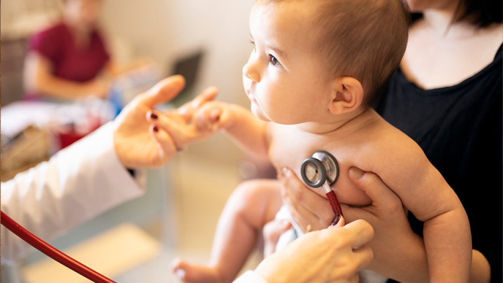 baby with stethoscope on heart