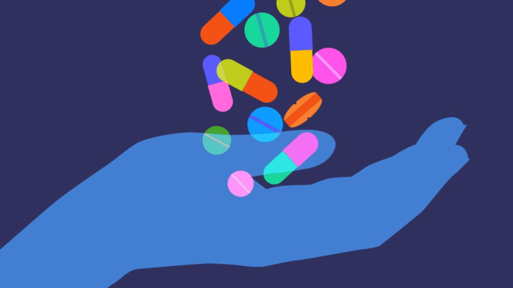 colorful pills falling into blue hand